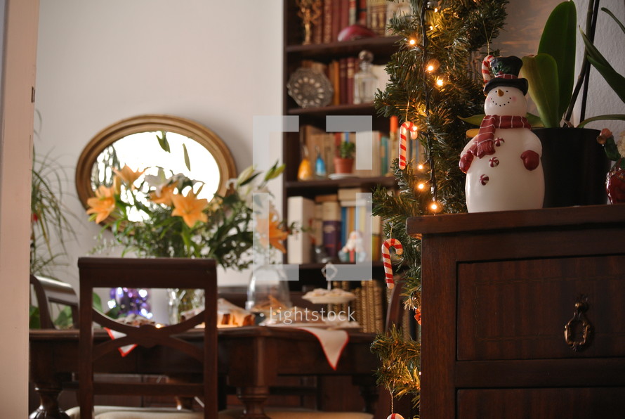 snowman and Christmas greenery in a home 