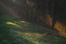 Sunlight on the old castle brick wall