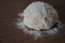Making bread - dough and flour on table
