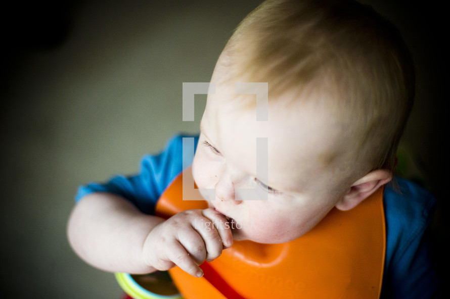 infant boy sucking his thumb 