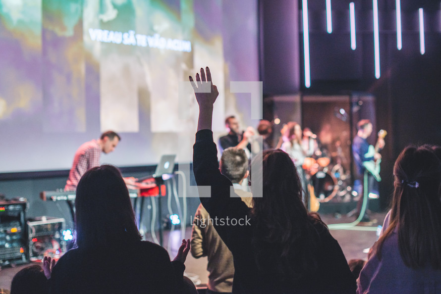 Woman with hands raised in worship