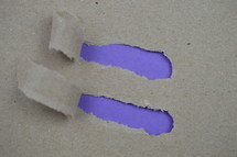 ripped paper revealing purple blank space for the words