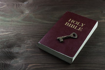 rusty key on a Bible - the key to understanding