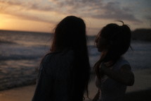 Young women at the beach at sunset