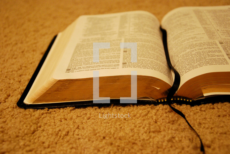 open Bible on a carpet