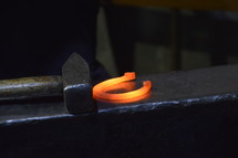 blacksmith working with a red-hot horseshoe