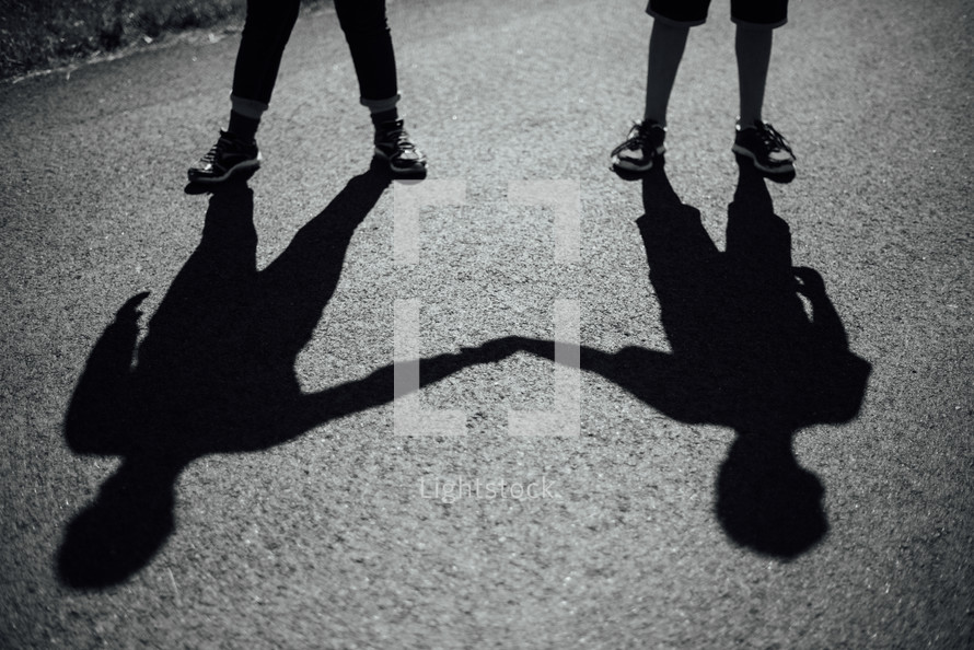 shadows of brothers holding hands 