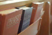 hymnals and Bibles in the back of church pews 