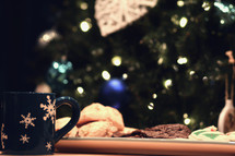 plate of Christmas cookies in front of a Christmas tree 