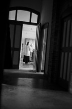 priest through a door 