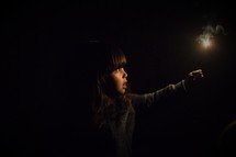 a little girl holding a sparkler at night 