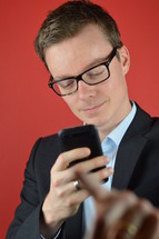 a businessman checking a text message and saying wait 