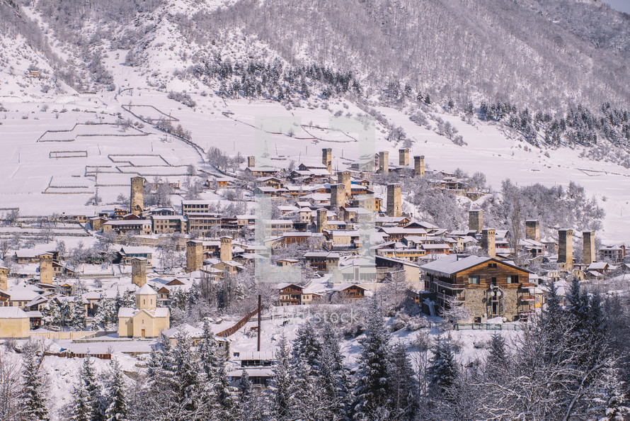 Snowy stone buildings in the mountain village 