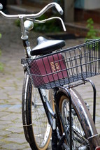old bikes with a bible in the bicycle basket, 