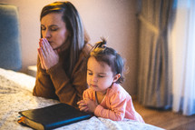 bedtime prayers with mother and daughter 