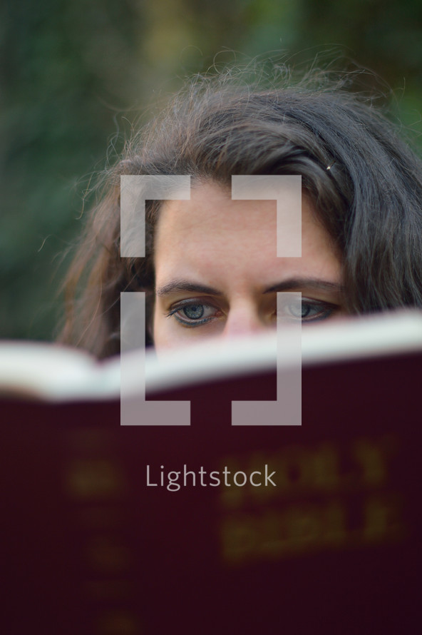eyes of a woman reading a Bible 