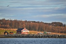 red barn along a shore 