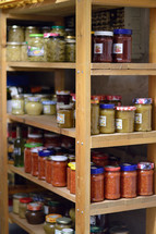 jars of preserved food on a pantry shelf 