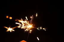 sparks from a sparkler at night 