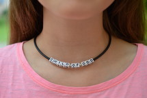 Child of God necklace around a woman's neck 