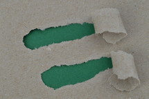 ripped paper revealing green blank space for words