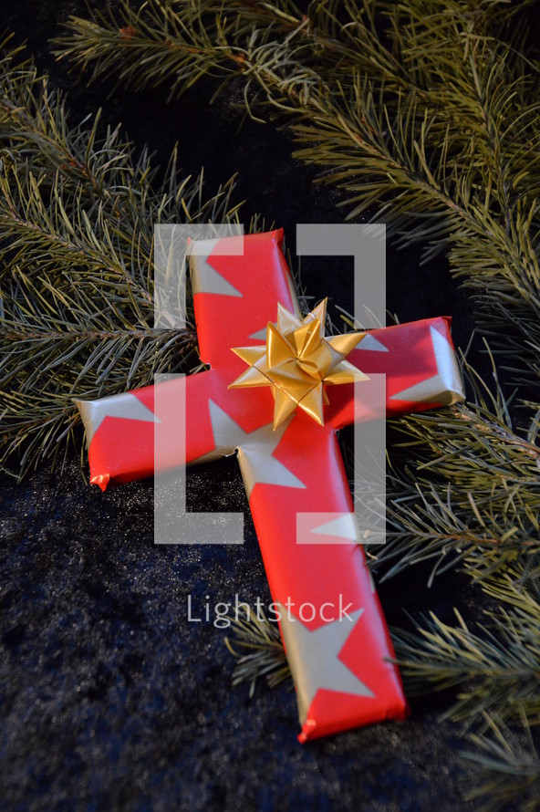 cross wrapped in paper as a present at Christmas day. 
presents, present, cross, Christmas, birth, death, born, die, dying, give, given, gave, son, advent, save, savior, saving, redeem, redeeming, redeemer, Christmas day, tree, fir, branch, twig, gift, star, stars, red, golden, wrap, wrapped, wrapping, wrap, packaging, packing, packed, pack, Xmas, fancy paper, gift wrap, wrapping paper