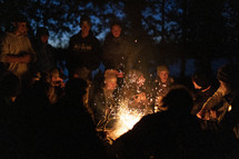 People sitting around a bonfire 