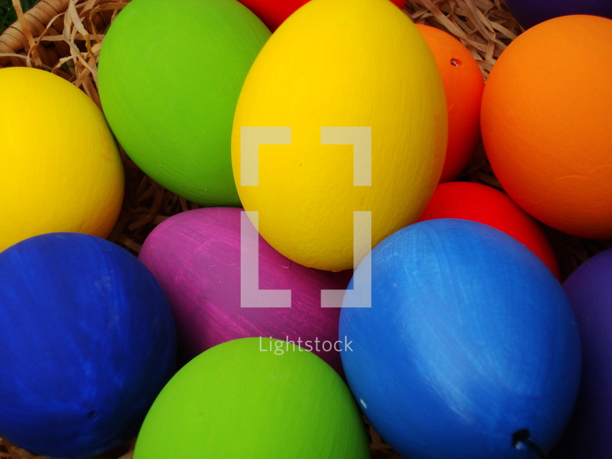 Multicolored Easter eggs in a basket. 
