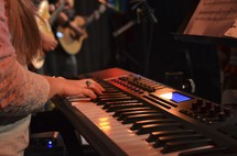 A woman playing a keyboard. 