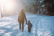 Father and son go for a walk in the snow