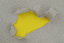 yellow under torn paper
