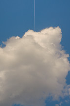 Conceptual Plane flying among white fluffy clouds 