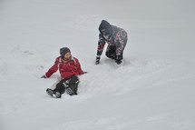 adults playing in the snow 