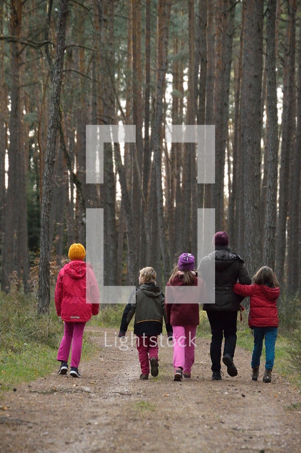 mother with her children on a stroll in the woods