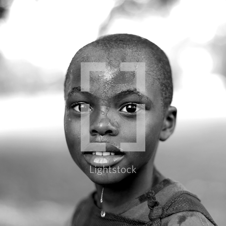 child with water on his face 