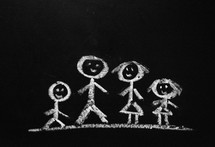 A chalk drawing of a stick figure family.