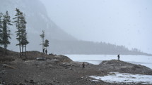 people walking along the shore of a frozen lake