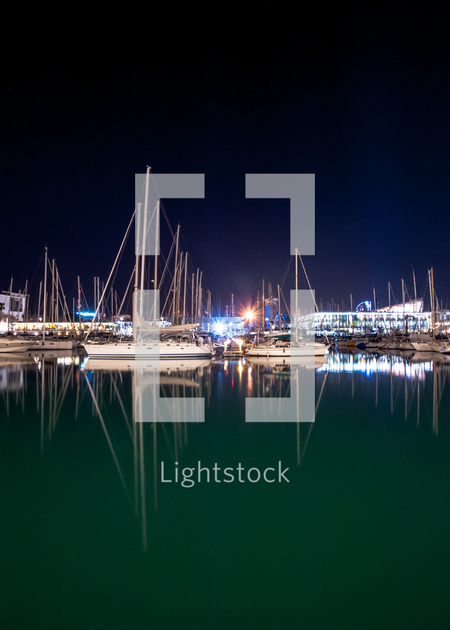 boats in a marina at night 