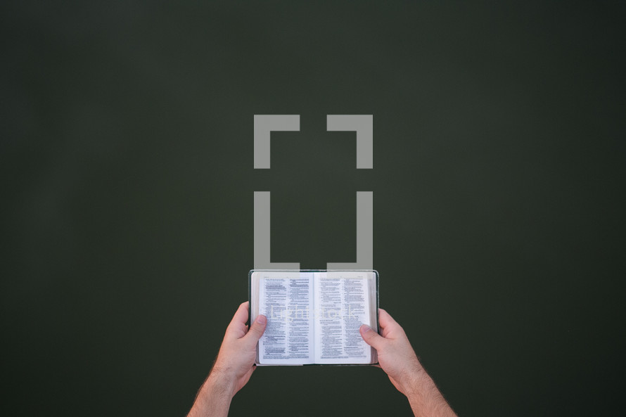 a man holding a pocket Bible 