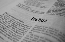 A Bible opened to the book of Joshua.
