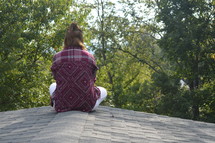 woman sitting on a roof 