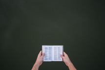 a man holding a pocket Bible 