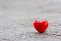 red heart on a wood background 
