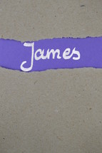 James - torn open kraft paper over lilac paper with the title James 