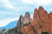jagged rugged red rock peaks against a blue sky 