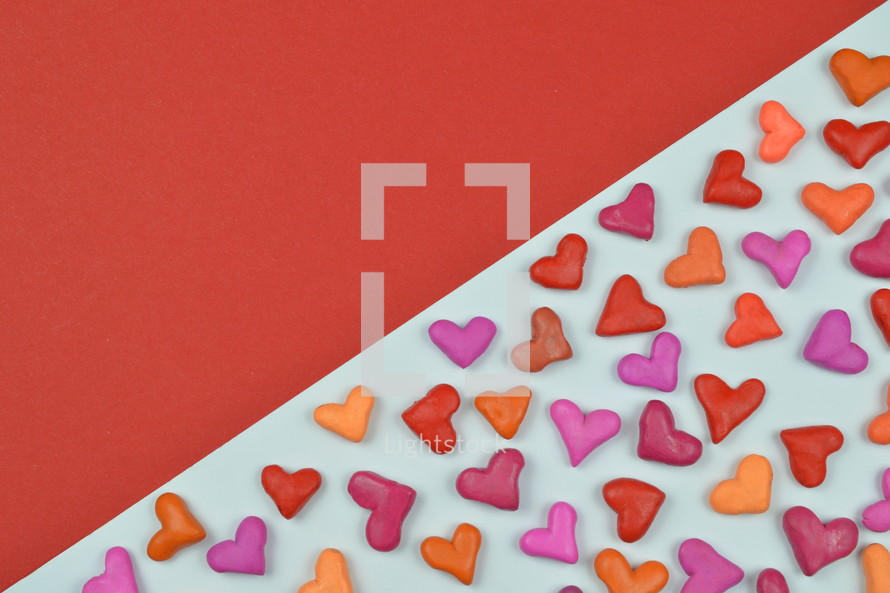 colorful heart shapes on red and white background 