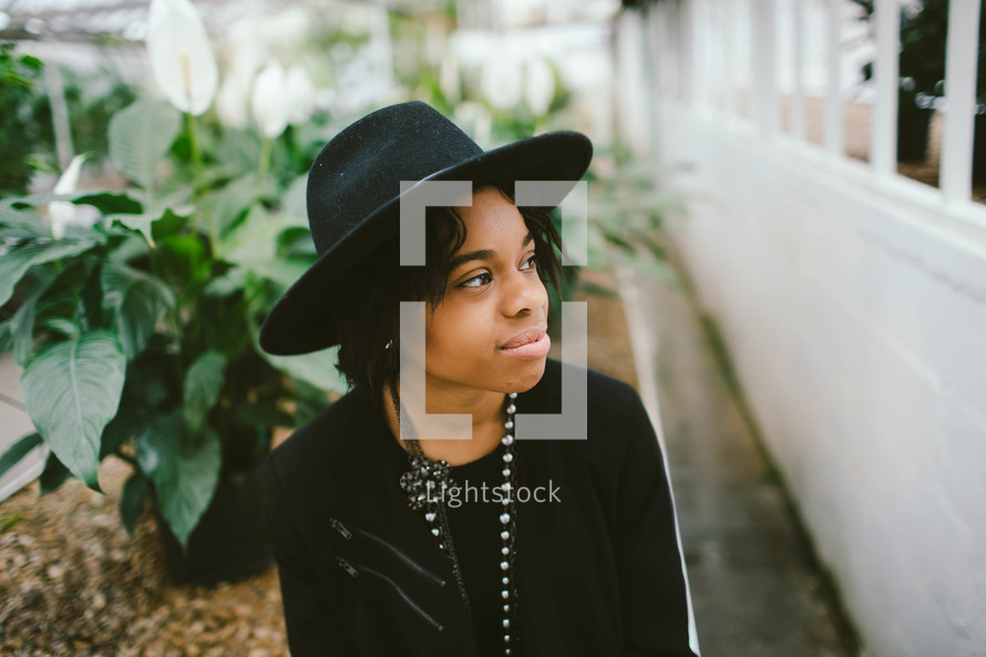 an African American woman in a black hat 