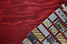 many little presents building a edge on red wooden background