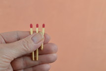 a person holding matches in their hand 