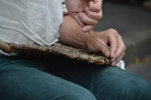 a man weaving a basket